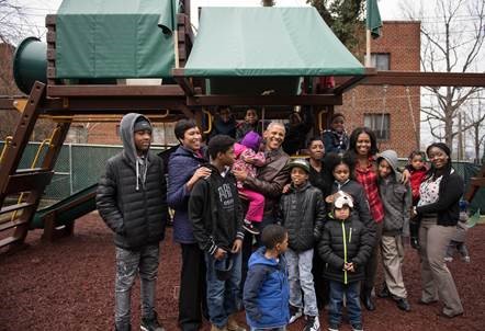 Group photo with Mayor Bowser, President Obama and First Lady on a playground with children