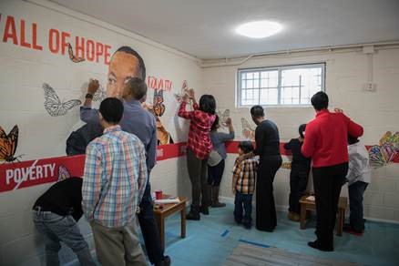 President Obama and First Lady Michelle Obama painting on a mural