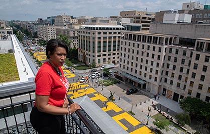 Mayor Bowser looks over 16th Street painted with Black Lives Matter